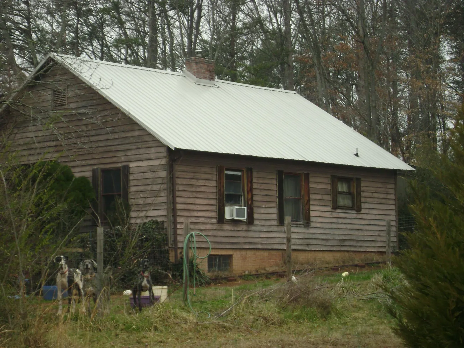 White metal roof on an old wood sided farmhouse, from a Metal Roof Installation job in Sanborn